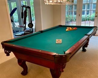 Lot 9002-A $1595.00. AMF 8' Pool Table, Stately table crafted in cherry, with green felt table  and sides, leather pockets, claw and ball feet, includes balls, triangle, all accessories, 4 pool cues and a bridge. If you've been looking for a pool table that looks as great as it plays, this is your table!