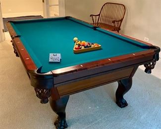 Lot 9002-A $1595.00. AMF 8' Pool Table, Stately table crafted in cherry, with green felt table  and sides, leather pockets, claw and ball feet, includes balls, triangle, all accessories, 4 pool cues and a bridge. If you've been looking for a pool table that looks as great as it plays, this is your table!