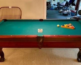 Lot 9002-A $1595.00. AMF 8' Pool Table, Stately table crafted in cherry, with green felt table  and sides, leather pockets, claw and ball feet, includes balls, triangle, all accessories, 4 pool cues and a bridge. If you've been looking for a pool table that looks as great as it plays, this is your table!