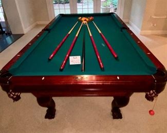 Lot 9002-A $1595.00. AMF 8' Pool Table, Stately table crafted in cherry, with green felt table  and sides, leather pockets, claw and ball feet, includes balls, triangle, all accessories, 4 pool cues and a bridge. If you've been looking for a pool table that looks as great as it plays, this is your table!