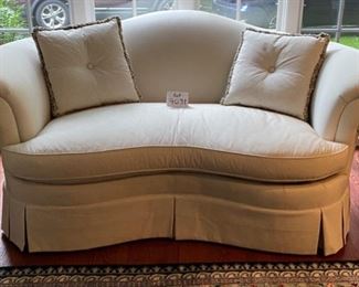 Lot 9031. $595.00. Hickory Chair curved Camel-Back Kidney shaped Settee  in Cream fabric with Black Dots.  74"w xx42"deep x34" H. 19" tall Cushion height.  Super comfortable, can dress this up for a formal setting, or add colorful pillows for a more laid-back look.  Hickory Chair is a very well-respected quality furniture manufacturer!  We believe this to be from their Sovereign Upholstery Collection.  