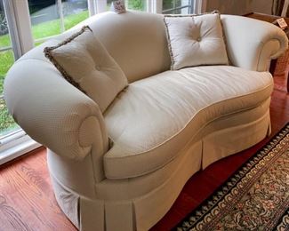 Lot 9031. $595.00. Hickory Chair curved Camel-Back Kidney shaped Settee  in Cream fabric with Black Dots.  74"w xx42"deep x34" H. 19" tall Cushion height.  Super comfortable, can dress this up for a formal setting, or add colorful pillows for a more laid-back look.  Hickory Chair is a very well-respected quality furniture manufacturer!  We believe this to be from their Sovereign Collection.  