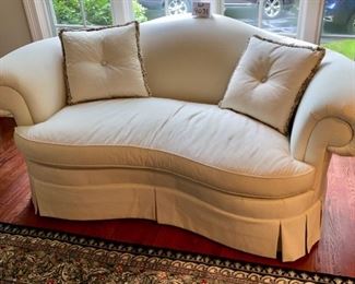 Lot 9031. $595.00. Hickory Chair curved Camel-Back Kidney shaped Settee  in Cream fabric with Black Dots.  74"w xx42"deep x34" H. 19" tall Cushion height.  Super comfortable, can dress this up for a formal setting, or add colorful pillows for a more laid-back look.  Hickory Chair is a very well-respected quality furniture manufacturer!  We believe this to be from their Sovereign Collection.  