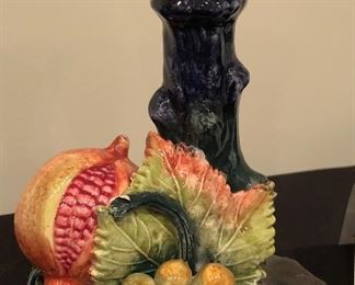 Lot 9024. $120.00 for A pair of  Ceramiche Fruited candlesticks, in cobalt blue with colorful, raised fruit base.