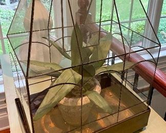 Lot 9041. $45.00. Cute Tabletop Vintage Greenhouse with leaded glass on little feet, 14.5" x 9.5" x 21" - Has faux plant in a stone pot in it currently, however you can certainly use this with live plants, and it has been used in the past for that as there are rusty spots for water,  Center panel on top does swing open to water, and entire top (heavy) does lift up to plant or prune or whatever!  This is so sweet.  I think a a live orchid in here would look smashing!