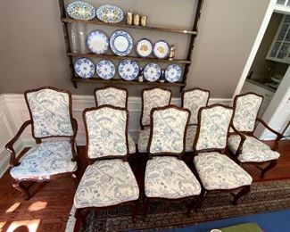 Lot 9086. $1600.00 FIRM. Lot of 8 Dining Chairs by Wellington Hall, which gave up their high-end furniture manufacturing operations in 2004.  Hekman may have purchased the brand name.   This lot includes  2 Captain (arm) Chairs, 6 Side Chairs.  Chairs are upholstered in Beige with a Heather Blue Floral Pattern.  A couple of the chairs' fabric may have been yellowed a bit by the sun, and one chair leg met their dog when she was apparently hungry!   Nice Chairs were very expensive new.  21" w x 18.5"Deep x 18" Seat to floor, 42" tall on the back.  Could use a little TLC but was quality built, so as we like to say, the chairs have "good bones" and the dog would say the chair tastes pretty fine as well.  