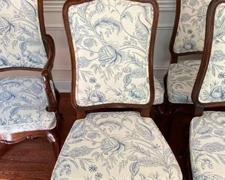 Lot 9086. $1600.00 FIRM. Lot of 8 Dining Chairs by Wellington Hall, which gave up their high-end furniture manufacturing operations in 2004.  Hekman may have purchased the brand name.   This lot includes  2 Captain (arm) Chairs, 6 Side Chairs.  Chairs are upholstered in Beige with a Heather Blue Floral Pattern.  A couple of the chairs' fabric may have been yellowed a bit by the sun, and one chair leg met their dog when she was apparently hungry!   Nice Chairs were very expensive new.  21" w x 18.5"Deep x 18" Seat to floor, 42" tall on the back.  Could use a little TLC but was quality built, so as we like to say, the chairs have "good bones" and the dog would say the chair tastes pretty fine as well.  