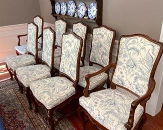 Lot 9086. $1600.00 FIRM. Lot of 8 Dining Chairs by Wellington Hall, which gave up their high-end furniture manufacturing operations in 2004.  Hekman may have purchased the brand name.   This lot includes  2 Captain (arm) Chairs, 6 Side Chairs.  Chairs are upholstered in Beige with a Heather Blue Floral Pattern.  A couple of the chairs' fabric may have been yellowed a bit by the sun, and one chair leg met their dog when she was apparently hungry!   Nice Chairs were very expensive new.  21" w x 18.5"Deep x 18" Seat to floor, 42" tall on the back.  Could use a little TLC but was quality built, so as we like to say, the chairs have "good bones" and the dog would say the chair tastes pretty fine as well.  