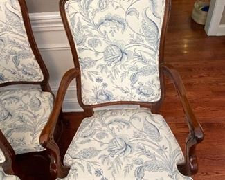 Lot 9086. $1600.00 FIRM. Lot of 8 Dining Chairs by Wellington Hall, which gave up their high-end furniture manufacturing operations in 2004.  Hekman may have purchased the brand name.   This lot includes  2 Captain (arm) Chairs, 6 Side Chairs.  Chairs are upholstered in Beige with a Heather Blue Floral Pattern.  A couple of the chairs' fabric may have been yellowed a bit by the sun, and one chair leg met their dog when she was apparently hungry!   Nice Chairs were very expensive new.  21" w x 18.5"Deep x 18" Seat to floor, 42" tall on the back.  Could use a little TLC but was quality built, so as we like to say, the chairs have "good bones" and the dog would say the chair tastes pretty fine as well.  