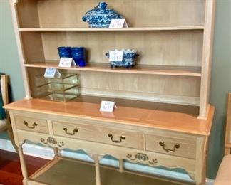 Lot 9095. $375.00. Weiman Pickled Oak Side Board and Hutch.  Sideboard has three pull out drawers, scalloped trim below that and a base open shelf above the leg knobs and it appears to have a couple stencils .  Hutch has same Scalloped feature below the top of the unit, and two shelves and sits right on the sideboard.  I believe it might have a little water damage on the lower shelf. Sideboard measures 64"w x 20"d x 32.5" tall.  Hutch measures 63" w x 12"deep x 38"tall