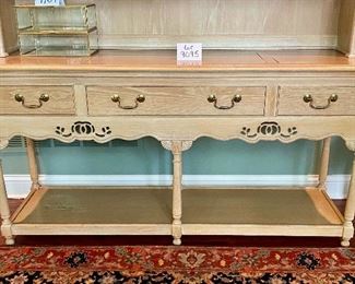 Lot 9095. $275.00  Weiman Pickled Oak Side Board and Hutch.  Sideboard has three pull out drawers, scalloped trim below that and a base open shelf above the leg knobs and it appears to have a couple stencils .  Hutch has same Scalloped feature below the top of the unit, and two shelves and sits right on the sideboard.  I believe it might have a little water damage on the lower shelf. Sideboard measures 64"w x 20"d x 32.5" tall.  Hutch measures 63" w x 12"deep x 38"tall