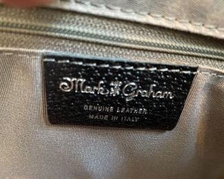 Lot 9149. $60.00. Mark & Graham Pebble Leather in Black Bucket Tote Bag or "Slouch Handbag". Features one inside zipper compartment, 2 more open pockets for stashing phone.  Made in Italy, has small monogrammed "N" on front, not problematic.  Made in Italy.  Expensive new.