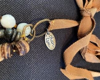 Lot 9143. $132.00. Lot of two interesting Designer Necklaces - one by Chan Luu and one by Marc Jacobs.  The Jacobs piece has a chain with stars and moon "charms"  and Chan Luu always seems to blend various textures of beads, colors, and ribbons.  