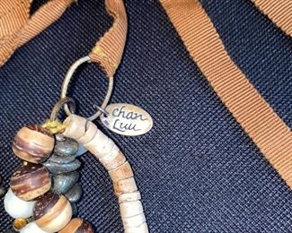 Lot 9143. $132.00. Lot of two interesting Designer Necklaces - one by Chan Luu and one by Marc Jacobs.  The Jacobs piece has a chain with stars and moon "charms"  and Chan Luu always seems to blend various textures of beads, colors, and ribbons.  