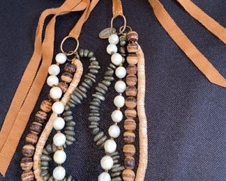 Lot 9143. $132.00. Lot of two interesting Designer Necklaces - one by Chan Luu and one by Marc Jacobs.  The Jacobs piece has a chain with stars and moon "charms"  and Chan Luu always seems to blend various textures of beads, colors, and ribbons.  