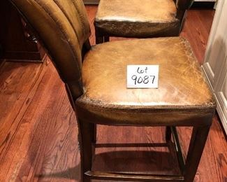 Lot 9087.   $360.00 for Three Williams-Sonoma bar stools with metal wrapped foot bar and nail head trim.  Faux leather with distressed look.  The stools retailed for over $1,000 each, yours for a fraction of that if you are the buyer!