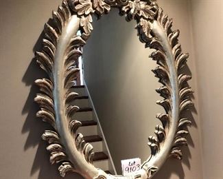 Lot 9103 #285.00. Beautiful, oval mirror with stunning  wood frame, highly detailed and finished in platinum/silver tones.