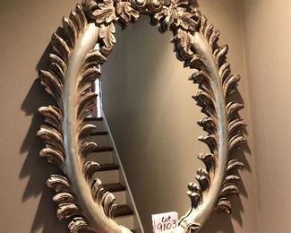 Lot 9103 #285.00. Beautiful, oval mirror with stunning  wood frame, highly detailed and finished in platinum/silver tones.