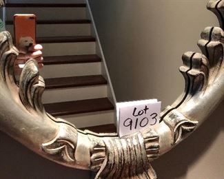 Lot 9103 #285.00. Beautiful, oval mirror with stunning  wood frame, highly detailed and finished in platinum/silver tones.