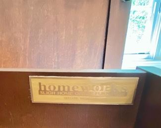 Lot 9171. $475.00.  Sligh Homeworks office/computer/ armoire/workstation, with a wood stained finish.  The large internal workspace includes keyboard drawer and storage. When you are finished with your project, the desk can be hidden away behind two large doors.	48.25" W x 71.5 T x 23.75" D