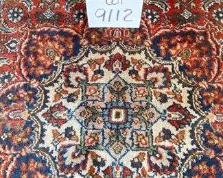 Lot 9112. $245.00. Pretty,  Unlabeled 4' x 6.5'  fringed area rug, in rust, cream & navy - wool.	Nice size for an entry way, foyer or under a cocktail table.