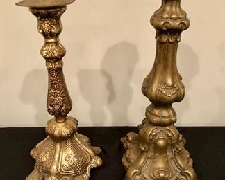 Lot 9114.  $70.00 This is a lot of two beautifully designed brass candlesticks with clear and precise imagery.  Both have raised, square bases.	14.5" x 5.5" base and 12" H x 5.5" base