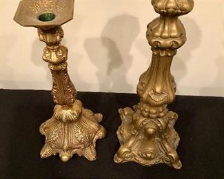 Lot 9114.  $70.00 This is a lot of two beautifully designed brass candlesticks with clear and precise imagery.  Both have raised, square bases.	14.5" x 5.5" base and 12" H x 5.5" base