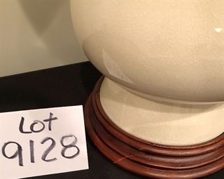 Lot 9128. $65.00  Cream colored, ceramic table lamp with wood base and finial.  Timeless stying , shade included.	28.5" T x 8" diam base, shade is 14" diam.