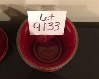 Lot 9133.  $50.00 2 red pots with attached saucers (6.5" diam x 5.5" T), made Portugal, and a wire hanging wall plant basket (23" W x 9.5" D x 15" T)