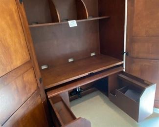 Lot 9171. $475.00.  Sligh Homeworks office/computer/ armoire/workstation, with a wood stained finish.  The large internal workspace includes keyboard drawer and storage. When you are finished with your project, the desk can be hidden away behind two large doors.	48.25" W x 71.5 T x 23.75" D