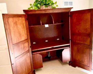 Lot 9171. $475.00.  Sligh Homeworks office/computer/ armoire/workstation, with a wood stained finish.  The large internal workspace includes keyboard drawer and storage. When you are finished with your project, the desk can be hidden away behind two large doors.	48.25" W x 71.5 T x 23.75" D