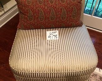 Lot 9178.  $225.00 each.  Two upholstered armless, slipper chairs in striped gold color tones and two Pottery Barn red & green paisley pillows.