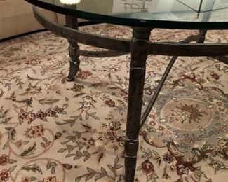 Lot 9179.  $330.00 Wrought iron frame and 1" thick glass on this oval shaped coffee table.  This is a wonderful piece and so heavy, the glass won't budge even when we try to slide it..