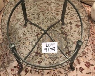 Lot 9179.  $330.00 Wrought iron frame and 1" thick glass on this oval shaped coffee table.  This is a wonderful piece and so heavy, the glass won't budge even when we try to slide it..