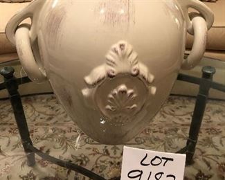 Lot 9182. $38.00 Cream colored, 2 handled ceramic vase, with a design in relief on the side.  