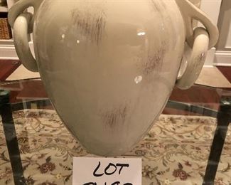 Lot 9182. $38.00 Cream colored, 2 handled ceramic vase, with a design in relief on the side.  