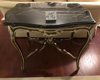 Lot 9186.  $325.00 Italian style wood table with embellished curved legs and a black and cream marble top.  Beautiful and certain to be a real conversation piece.	34" W x 26" D x 32" H