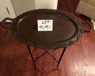 Lot 9191. $125.00 This interesting side table is actually a very heavy, handled tray that sits on a stand that is equally sturdy and attractive.  Note the bamboo leg design.	25.5" W x 15.5" D x 26" H