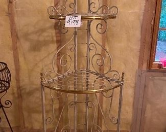 Lot 9198. $50.00. Up for sale is an attractive, heavy metal, corner triple shelf.  It has a white finish with brass trim and accents.  Great storage for a small space.	25"W x 64" T x 16"D.  Plants look terrific on these corner shelve as well.