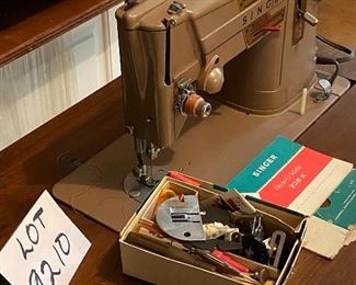 Lot 9210. $165.00 Vintage Singer Model 328K Stylomatic Singer Sewing machine in cabinet.  Includes original metal attachments and some sewing notions and bench seat. 26" W x 17" D 
