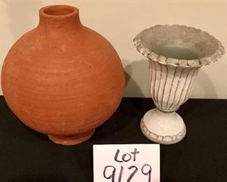 Lot 9129.  $28.00 Lot of two unique vases: a terra cotta vase with wide body and narrow neck and a glazed pottery vase on a square base.	terra cotta vase: 10" T x 7"W and pottery vase 7.5"T  x 5.5"