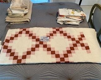 Lot 9175.  $65.00 Vintage rose colored, solid and floral print, hand stitched quilt.	90" L x 80" W