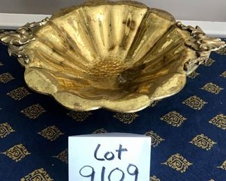Lot 9109.  $40.00 Hammered brass footed, serving bowl with handles and 4 cranberry glass S/P shakers.


