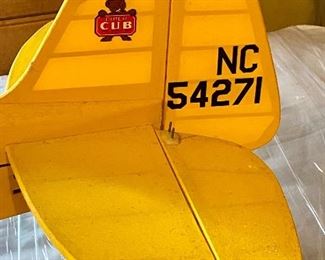 Lot 9214. $150.00  Piper Cub Radio Control Airplane, in a vibrant yellow color.  All decals in place and in good condition, all parts are with this plane. NC54271.  No Remote control	48" L x 77" W wingspan