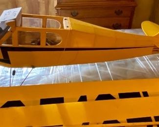 Lot 9214. $150.00  Piper Cub Radio Control Airplane, in a vibrant yellow color.  All decals in place and in good condition, all parts are with this plane. NC54271.  No Remote control	48" L x 77" W wingspan