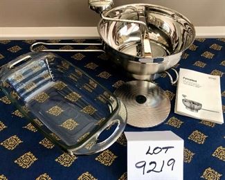 Lot 9219. $50.00.  Another cooking lot, a Rosle Passetout stainless steel food mill and a Fire King clear glass loaf pan with handles.