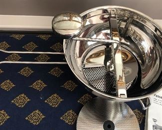 Lot 9219. $50.00.  Another cooking lot, a Rosle Passetout stainless steel food mill and a Fire King clear glass loaf pan with handles.