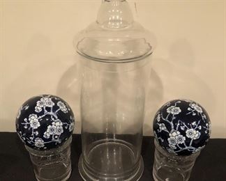 Lot 9230.  $55.00.  Apothecary jar (19.5"H x 6"W), 2 glass pots (5"H x 4"W), and 2 cobalt and white floral spheres (4.5" diam).