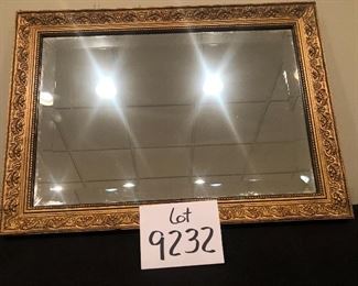 Lot 9232.  $60.00.  Pottery Barn candles in a brass holder (4.5"H x 3"W) and a gold bevelled mirror (15"H x 21W).