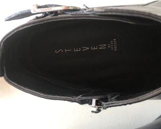 Lot 9148  $55.00. Steve Madden Super Nice Black Leather ankle boots, ladies size 9, purchased at Anthropologie for $128.00, sale price and still have sticker on the bottom - appear to only have been worn once, in excellent used condition.  The shoes have very slight silver studs around the base of the boot - looks classy, with a buckle on either side next to the zipper. 
